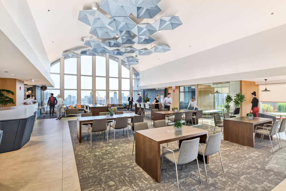 225 W. Wacker — Downtown office amenity lounge with lounge seating, dining tables, and acoustic ceiling.