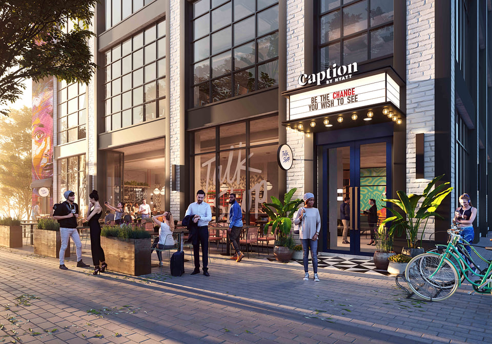 Hospitality hero exterior rendering, daytime three-quarter view with brand-standard signage.
