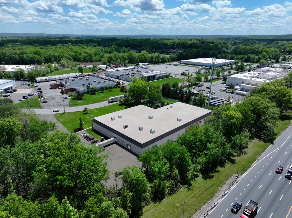 Industrial rendering — cross-dock distribution facility with deep truck court and trailer parking