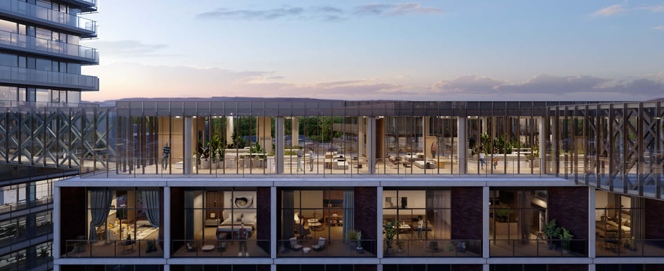 Cutaway 'dollhouse' rendering of a mixed-use building revealing furnished residential units below and a glass-walled rooftop coworking lounge above at dusk