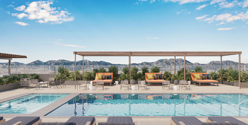 Rendering of a rooftop pool deck with a slatted timber pergola, orange chaise loungers, and a distant hillside view at sunrise