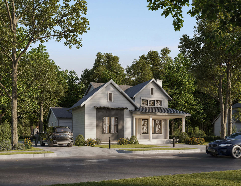 Modern farmhouse single-family home exterior with front porch and wooded setting